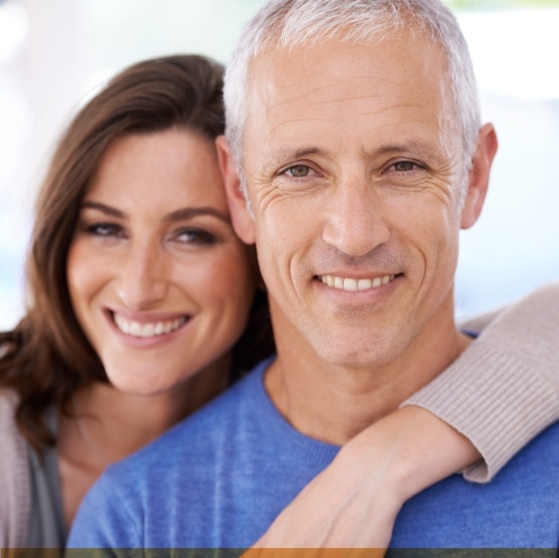 Smiling woman and man hugging