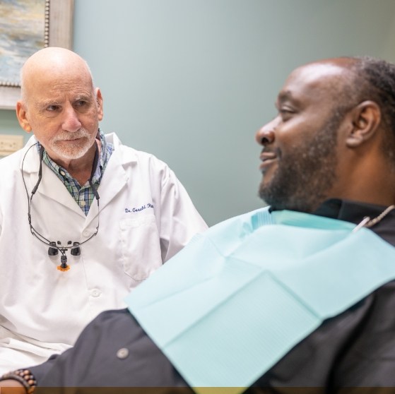 Dental patient talking to his dentist