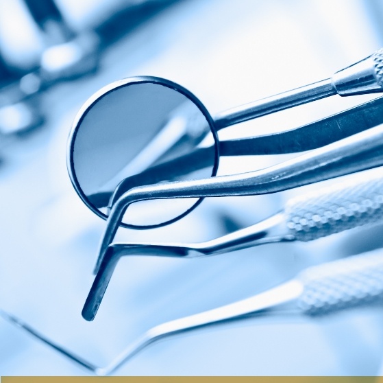 Dental mirror and scaler on a metal tray