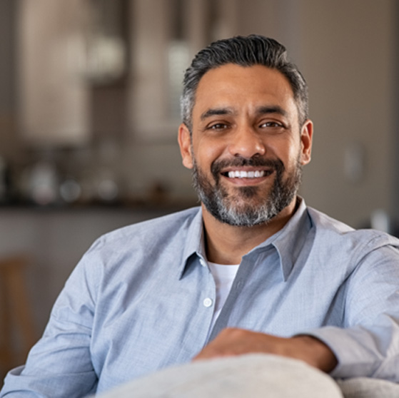Man smiling while sitting in couch at home