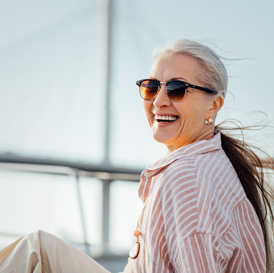 Woman with sunglasses smiling on boat
