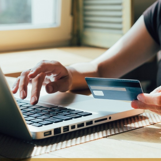 Person entering credit card information on a laptop