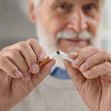 Closeup of man breaking cigarette