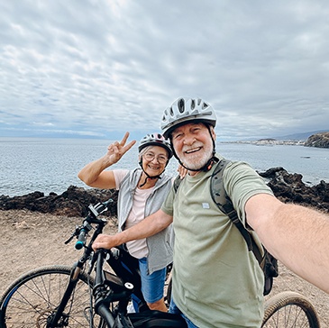 Couple taking selfie while riding bikes