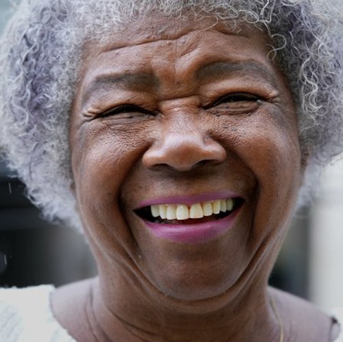 Woman smiling brightly in the rain