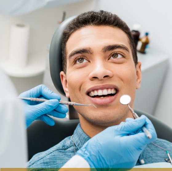 Man smiling at his dentist during a preventive dentistry checkup